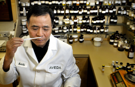 Ko-Ichi Shiozawa, chief perfumer at Aveda, smells a scent sample containing 15 essential oils that will be featured in a new Aveda shampoo and conditioner, available next year, at their Minnetonka, Minneapolis office, July 30, 2008./ppBehind him are samples of hundreds of essential oils./pp(Glen Stubbe/Minneapolis Star Tribune/MCT)